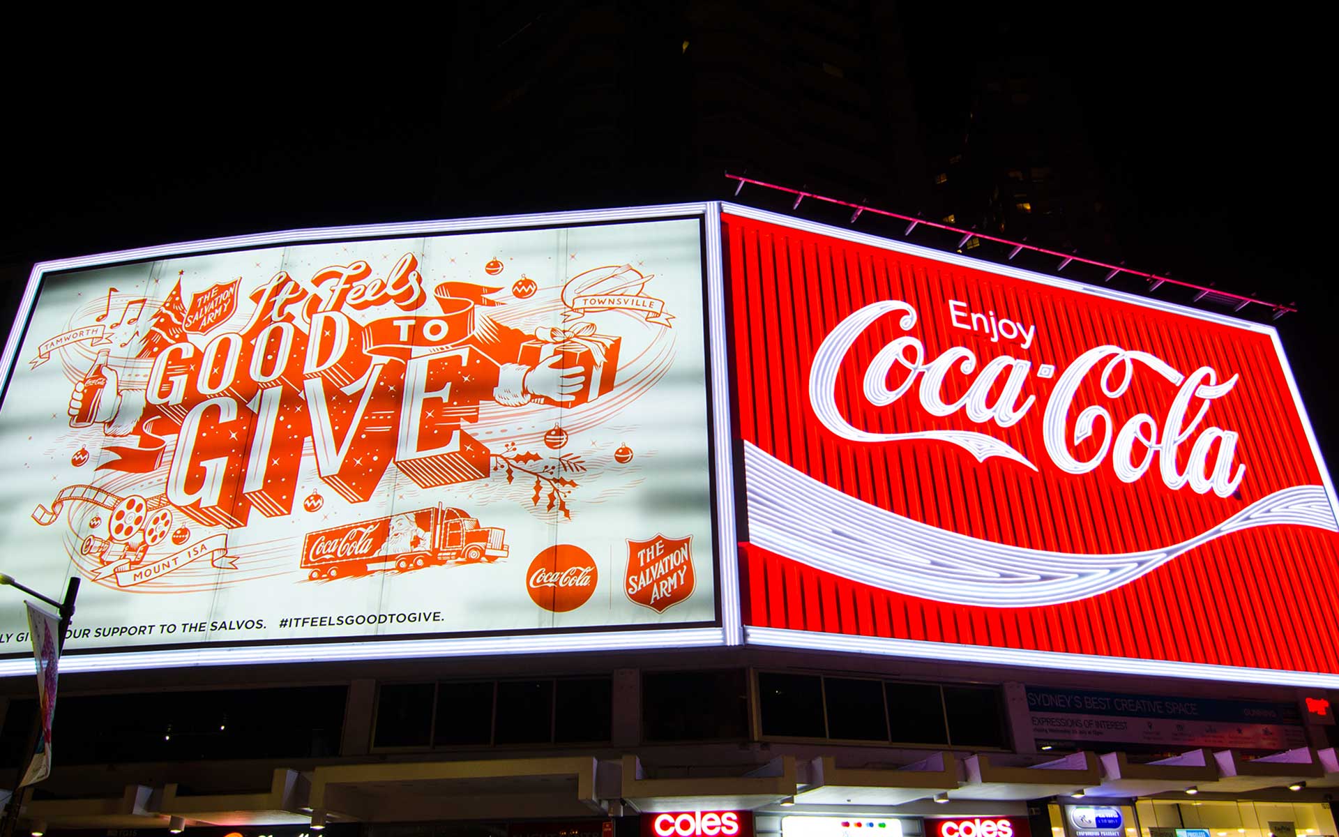 A digital billboard with Coca-Cola ads